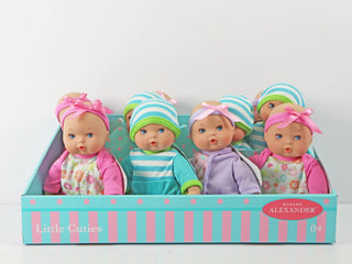 A box of Madame Alexander 8" Little Cuties Baby Dolls, featuring multiple dolls with various colorful outfits and hats.