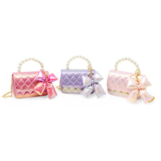 Girl carrying shiny quilted fluffy bow handbag