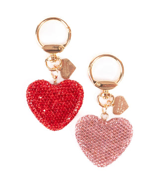 Heart-shaped keychains with gold rings on a white background