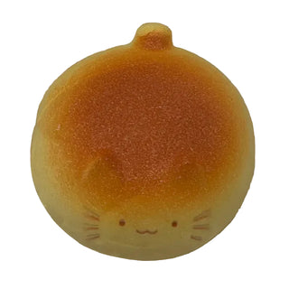 Round bread product with cat face design on a clear plastic bag