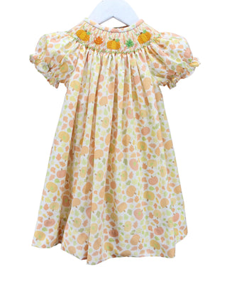 Baby Blessings smocked bishop dress with stitched pumpkins and fall leaves on a peach pumpkin print