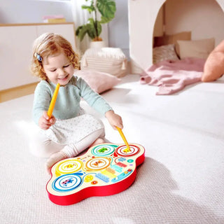 Hape toy drum with drumstick storage on the back