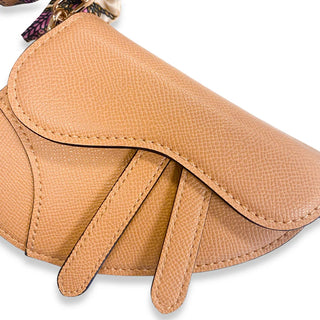 Beige Doe-A-Dear saddle purse with tied scarf
