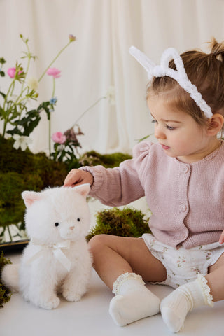 Child cuddling Jamie Kay Moon the Kitty plush