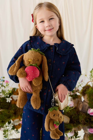 Child holding Jamie Kay Strawberry Penelope bunny