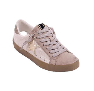 Pink sneaker with a gold star on a light gray background