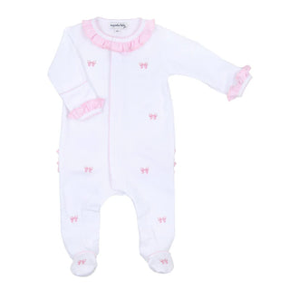 A white baby footie with pink embroidered bows and ruffled detailing at the neckline and cuffs.