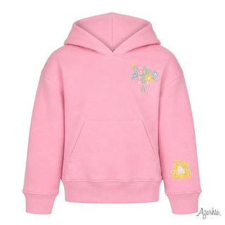A pink pullover hoodie with a small multicolor floral embroidery on the left chest and a yellow flower embroidery on the right sleeve, shown against a plain white background.