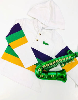 A white cotton hoodie with half buttons, featuring green, orange, and purple stripes and a green decorative item resembling a saxophone.
